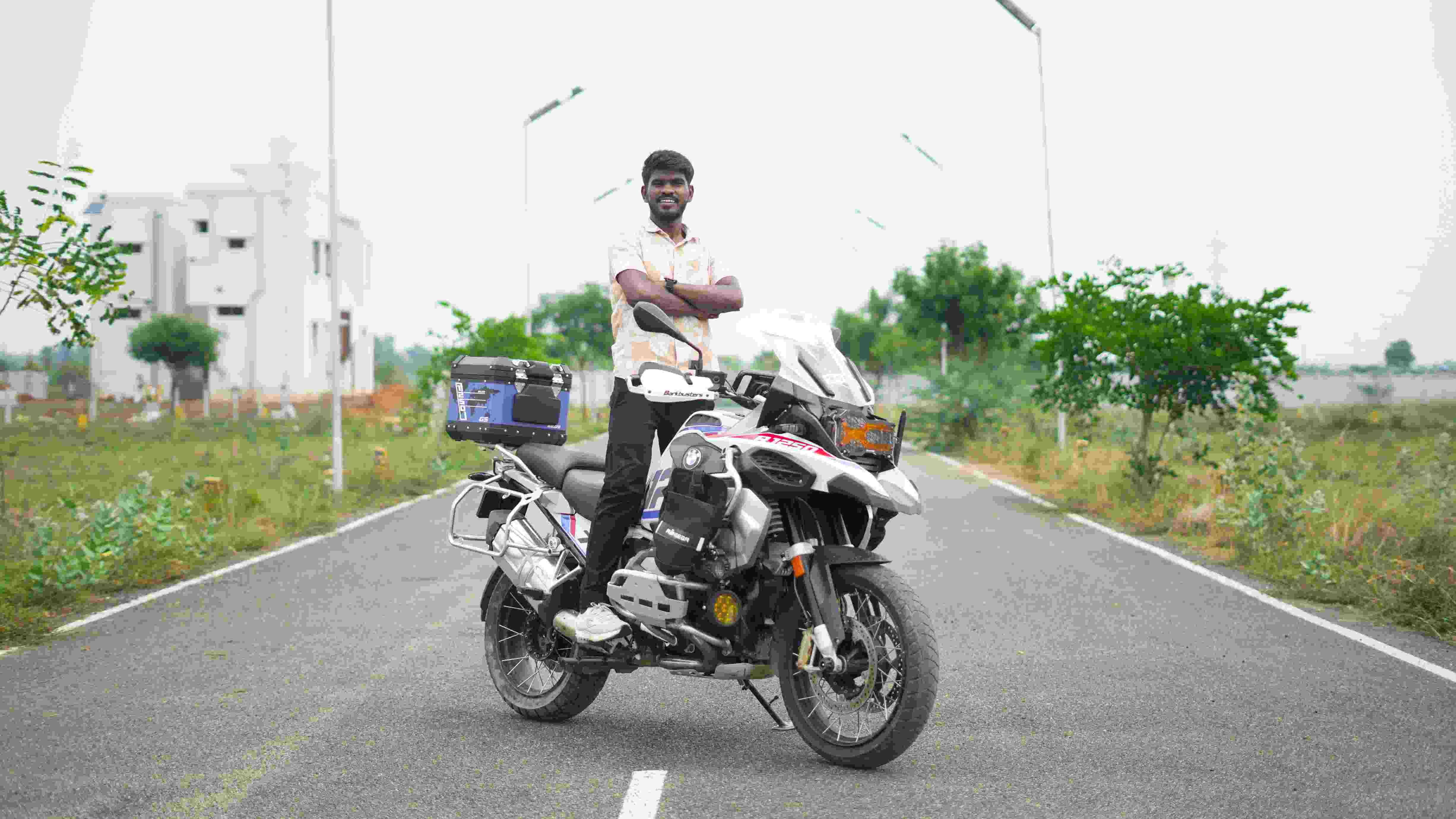 Adventure touring bike with rider posing on road