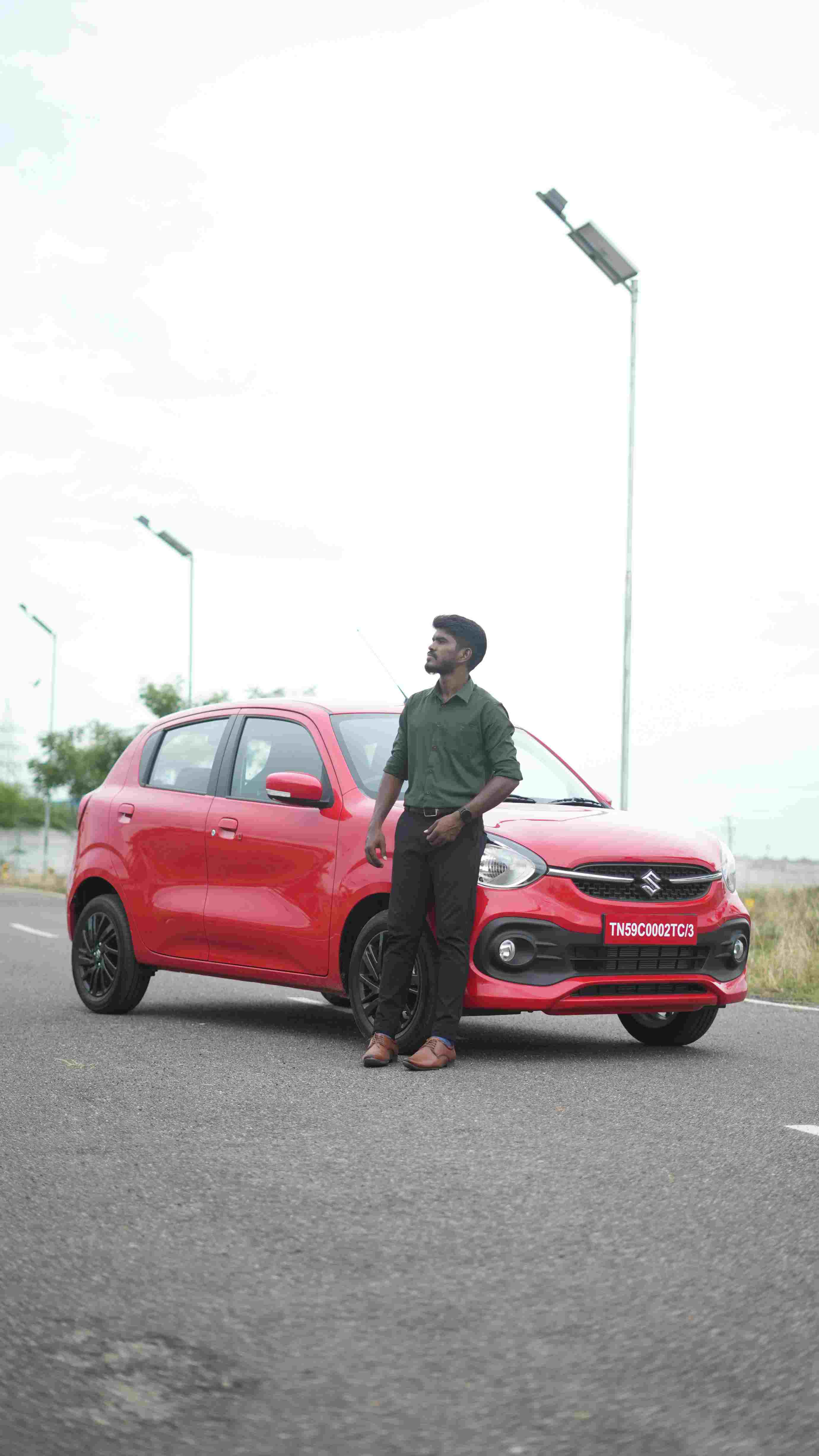 Red hatchback roadside parked
